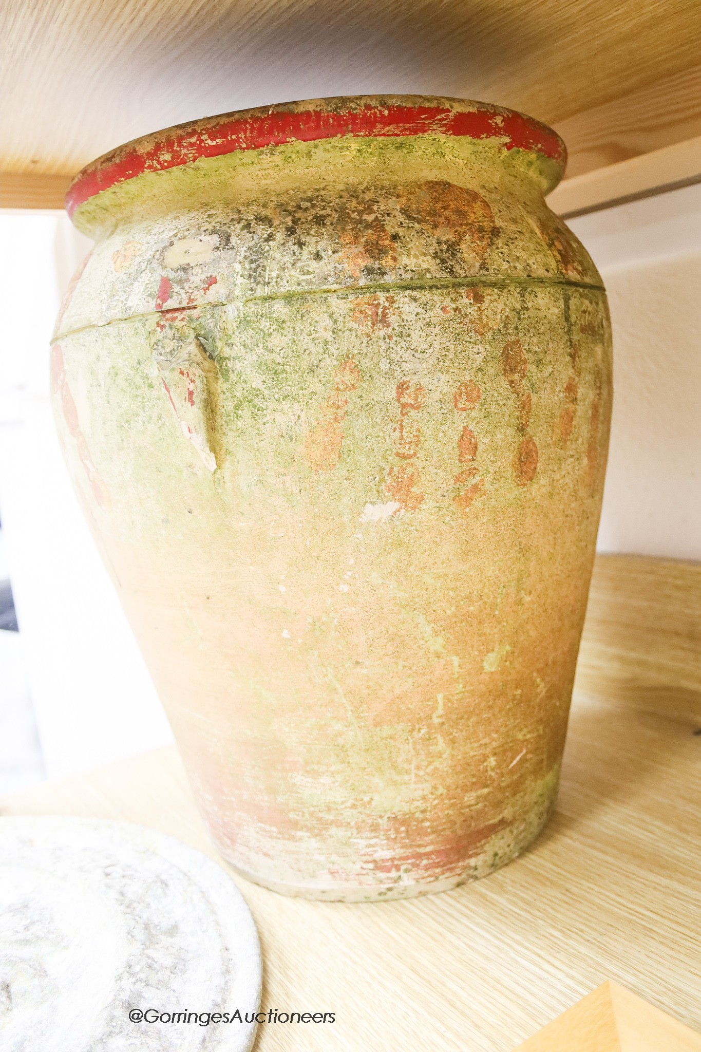 A Roman-style terracotta pot, height 40cm, and a Roman headed cartouche